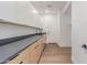 Bright laundry room with modern cabinets, gray countertops, and wood-look flooring at 13367 W Jesse Red Dr, Peoria, AZ 85383
