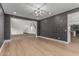 Spacious living room featuring wood floors and elegant lighting fixture at 13367 W Jesse Red Dr, Peoria, AZ 85383