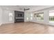 Open living room boasts a fireplace and large windows that bring in natural light and backyard views at 13367 W Jesse Red Dr, Peoria, AZ 85383