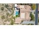 Aerial view of the house and its backyard with a pool, spa, fire pit, and putting green at 13750 E Yucca St, Scottsdale, AZ 85259