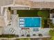 An aerial view of a backyard with a pool, hot tub, lounging area, fire pit, and putting green at 13750 E Yucca St, Scottsdale, AZ 85259
