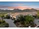 An aerial view shows a private home with an expansive three-car garage and desert landscaping at 13750 E Yucca St, Scottsdale, AZ 85259