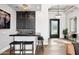 Stylish bar area with dark cabinets, a tile backsplash, a chandelier, and seating for three at 13750 E Yucca St, Scottsdale, AZ 85259