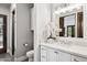 Well-lit bathroom featuring a quartz countertop vanity, modern fixtures, and a glass-enclosed shower at 13750 E Yucca St, Scottsdale, AZ 85259
