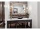 Unique powder room featuring a stone countertop, stone backsplash, vessel sink, and unique lighting at 13750 E Yucca St, Scottsdale, AZ 85259