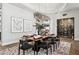 A luxury dining room includes an elegant chandelier, modern artwork, and a climate-controlled wine storage unit at 13750 E Yucca St, Scottsdale, AZ 85259