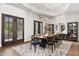 Elegant dining room featuring a large table, unique rug, modern light fixture, and plenty of natural light at 13750 E Yucca St, Scottsdale, AZ 85259