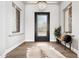 Elegant foyer with wood floors, chandelier, and a decorative front door at 13750 E Yucca St, Scottsdale, AZ 85259