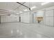 Spacious garage with epoxy floors, overhead storage, and ample cabinet space at 13750 E Yucca St, Scottsdale, AZ 85259