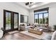 Open-concept living room boasts a comfortable couch and backyard access through glass doors at 13750 E Yucca St, Scottsdale, AZ 85259
