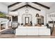 Spacious living room with a fireplace, high ceilings, and a large sofa, open to the kitchen and entrance at 13750 E Yucca St, Scottsdale, AZ 85259