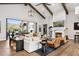 Bright and airy living room with high ceilings, exposed beams, a fireplace, and access to the backyard at 13750 E Yucca St, Scottsdale, AZ 85259