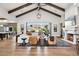 Bright living room with high ceilings, exposed beams, fireplace, and sliding glass doors to the backyard at 13750 E Yucca St, Scottsdale, AZ 85259