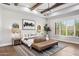 Spacious main bedroom with a king bed, ceiling fan, and an eye-catching piece of modern artwork at 13750 E Yucca St, Scottsdale, AZ 85259