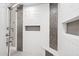 Modern walk-in shower featuring beautiful tile work and built-in storage at 13750 E Yucca St, Scottsdale, AZ 85259