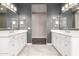 This bathroom boasts dual vanities, modern fixtures, and a view into the neutral room ahead at 13850 W Weaver Ct, Litchfield Park, AZ 85340
