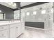 Modern bathroom featuring double showers, white marble, and a sleek vanity at 13850 W Weaver Ct, Litchfield Park, AZ 85340