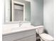 Bathroom featuring a white vanity with sink, a mirror, and a toilet with light blue walls at 13850 W Weaver Ct, Litchfield Park, AZ 85340