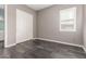 This bedroom is complete with a shuttered window and a double sliding-door closet at 13850 W Weaver Ct, Litchfield Park, AZ 85340