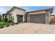 Contemporary home with two garages and a brick-paved driveway at 13850 W Weaver Ct, Litchfield Park, AZ 85340