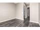 Neutral hallway with gray walls and wood-look tile flooring leads to bathroom and bedroom at 13850 W Weaver Ct, Litchfield Park, AZ 85340