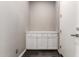 Hallway features a built in storage unit with white cabinets and drawers at 13850 W Weaver Ct, Litchfield Park, AZ 85340