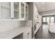 A closer view of the kitchen showcasing white cabinets, countertops, and tile backsplash at 13850 W Weaver Ct, Litchfield Park, AZ 85340
