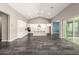 Spacious kitchen with white cabinets, stainless steel appliances, an island, and grey tiled flooring at 13850 W Weaver Ct, Litchfield Park, AZ 85340