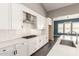 The kitchen features white cabinets, countertops, tile backsplash, and stainless steel appliances at 13850 W Weaver Ct, Litchfield Park, AZ 85340