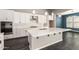 Kitchen with stainless steel appliances, white countertops, white tile backsplash, and stylish lighting at 13850 W Weaver Ct, Litchfield Park, AZ 85340