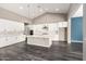 Bright, open kitchen with white cabinets, a large island, and modern pendant lighting at 13850 W Weaver Ct, Litchfield Park, AZ 85340