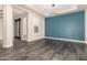 Open living room with tile floors, modern lighting, and a stylish accent wall at 13850 W Weaver Ct, Litchfield Park, AZ 85340