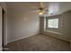 Bedroom with a ceiling fan, window bench seating and carpet at 13921 W Port Royale Ln, Surprise, AZ 85379