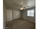 Cozy bedroom with carpet flooring, closet, and natural light from the window at 13921 W Port Royale Ln, Surprise, AZ 85379