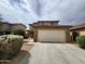Charming two-story home featuring a two-car garage, desert landscaping, and a tile roof at 13921 W Port Royale Ln, Surprise, AZ 85379