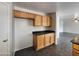 Kitchen with wooden cabinets, ample countertop space, and views to the living room at 13921 W Port Royale Ln, Surprise, AZ 85379