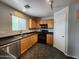 Well-equipped kitchen featuring stainless steel appliances, wood cabinets, and a modern sink at 13921 W Port Royale Ln, Surprise, AZ 85379