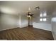 Spacious living room features a modern ceiling fan and beautiful wood-look floors at 13921 W Port Royale Ln, Surprise, AZ 85379