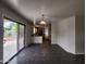 Open floor plan showcasing tile flooring with views of the kitchen and sliding glass doors at 13921 W Port Royale Ln, Surprise, AZ 85379