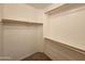 Walk-in closet with wooden clothing racks and carpet flooring at 13921 W Port Royale Ln, Surprise, AZ 85379