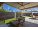 Relaxing backyard area features outdoor seating, putting green, and an umbrella-covered dining set at 1461 W Tara Dr, Gilbert, AZ 85233