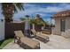 Backyard featuring a spa, lounge chairs, and a modern patio heater for relaxation at 1461 W Tara Dr, Gilbert, AZ 85233