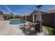 Backyard oasis with a pool, lounge chairs, and outdoor dining area at 1461 W Tara Dr, Gilbert, AZ 85233