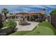 Entertainer's backyard with a swimming pool, covered patio, putting green and outdoor kitchen at 1461 W Tara Dr, Gilbert, AZ 85233