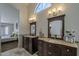 Bathroom features dual sinks with dark wood cabinets, granite countertops and natural light, with bedroom access at 1461 W Tara Dr, Gilbert, AZ 85233