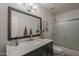 Bathroom featuring a dark vanity with a marble countertop, plus a shower over the bath at 1461 W Tara Dr, Gilbert, AZ 85233