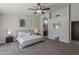 Bright bedroom features neutral tones, fan, art, and ensuite access to the bathroom, offering style and comfort at 1461 W Tara Dr, Gilbert, AZ 85233