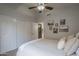 Bedroom with a ceiling fan and a double door closet; features art and ensuite access at 1461 W Tara Dr, Gilbert, AZ 85233