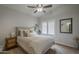 Neutral bedroom with a ceiling fan, window with shutters, and a side table with a bedside lamp at 1461 W Tara Dr, Gilbert, AZ 85233