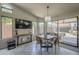 A dining area with a chandelier, large windows, and a view of the backyard patio at 1461 W Tara Dr, Gilbert, AZ 85233